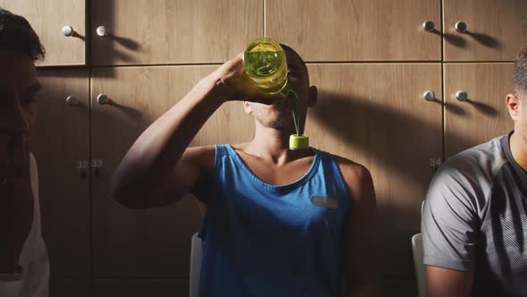 Soccer player drinking water in the locker room