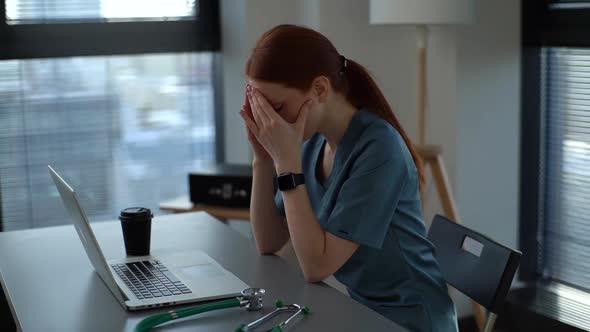 Side View of Tired Exhausted Young Female Doctor in Medical Uniform Having Headache and Rubbing Head