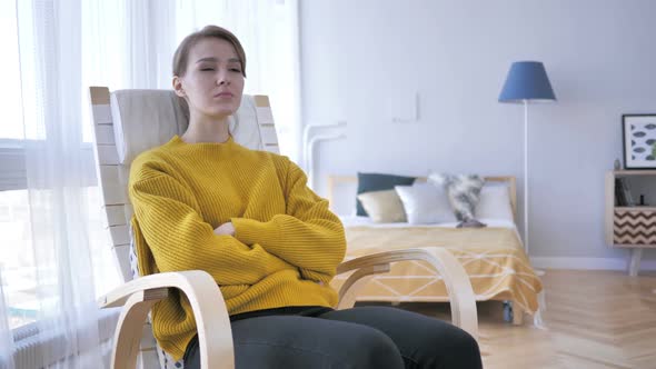 Young Woman Sitting on Casual Chair Brainstorming