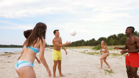 Happy Friends Playing Ball on Summer Beach 