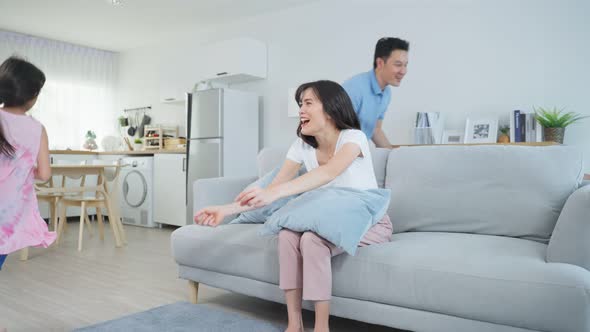 Asian family spending time together on holiday in living room at home.