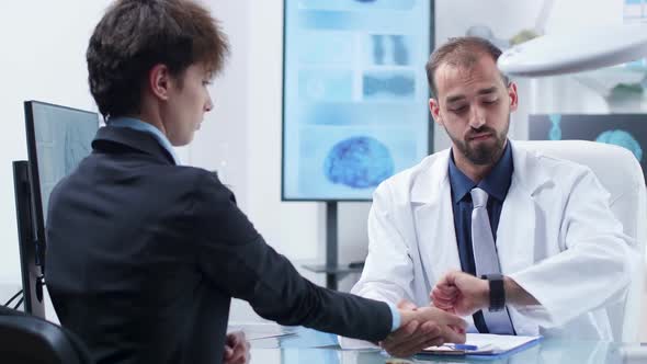 Physician Taking Pulse To an Young Woman