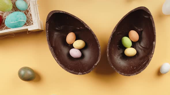 Chocolate Easter Egg with Surprise on Yellow Background