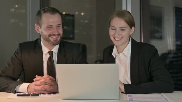 Business People Doing Video Chat on Laptop at Night 