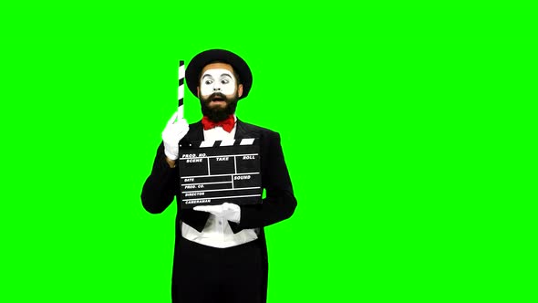 Man Mime Sneezes Using the Movie Clapper on Green Screen