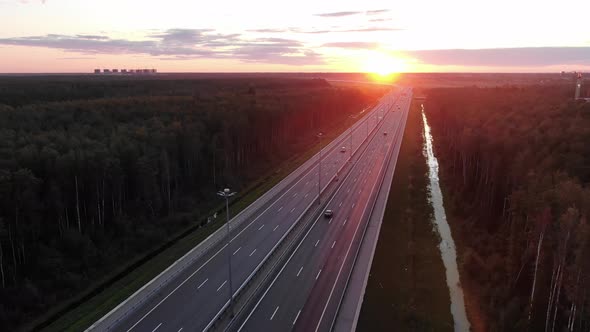 Motion Over Wide Highway with Driving Cars and Canal Aside