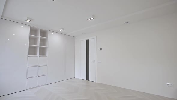 Vacant Unfurnished Room Interior with Wooden Herringbone Parquet Floor and White Walls