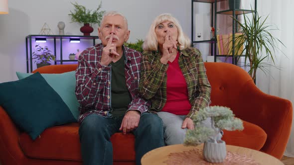 Senior Elderly Family Grandparents Man Woman Presses Index Finger to Lips Makes Silence Gesture