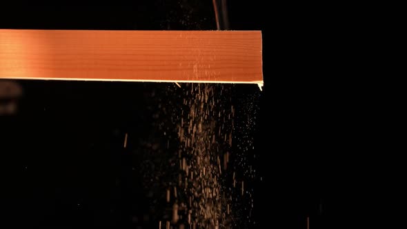 Man Carpenter Saws a Wooden Board with a Hand Saw