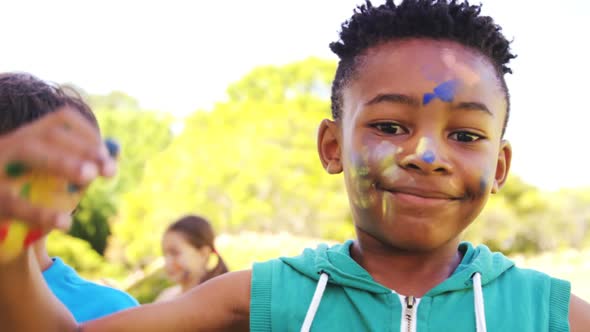 Kids with painted face and hands in park