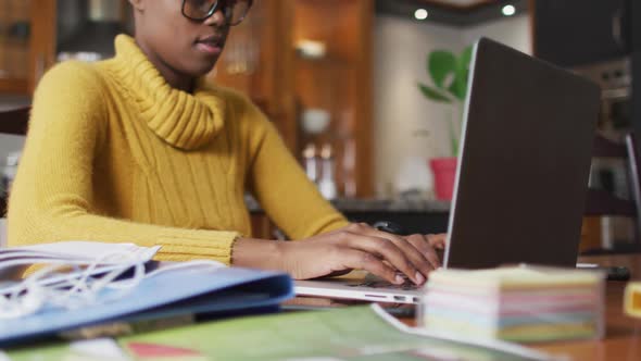 African american woman using laptop while working from home