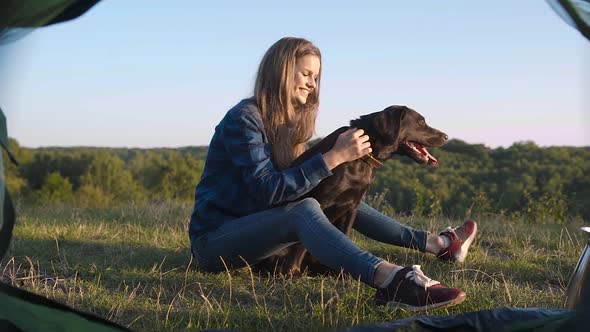 Camping. Happy Woman Traveling With Dog In Nature