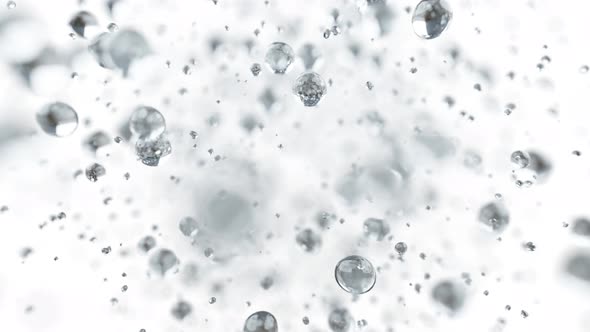 Explosion of Water Droplets Into the Camera in Slow Motion on an Isolated White Background. alt