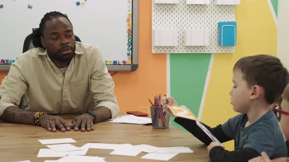 African American Teacher Teaches a Group of Children Mathematics in the Classroom