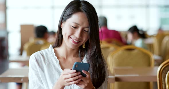 Woman use of smart phone in the coffee shop