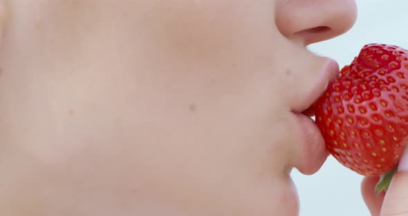 Close Up of Woman Eating Fresh Ripe Strawberry