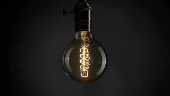 Edison Old Retro Light Bulb Lamp Shaking Over Black Background, FHD, 