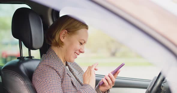 A 40Yearold Woman is Driving in a Car and Chatting Online Through a Smartphone with Her Boyfriend