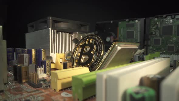 Golden Coins with Bitcoin Symbol on a Main Board Computer. Popular Gold Cryptocoin Bitcoin on the