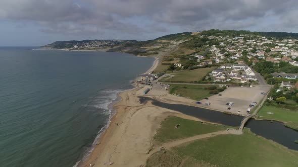 Aerial of Charmouth, Dorset. Facing west, tracking forward and straight. Home of UK fossil hunting.