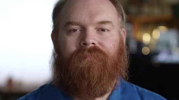 Black look on the face of man with red thick beard