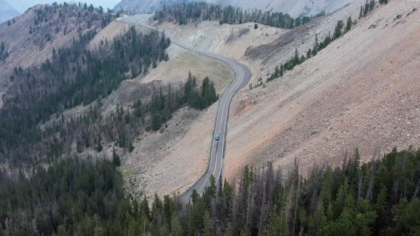 Aerial, car driving on American national park road on cliff side