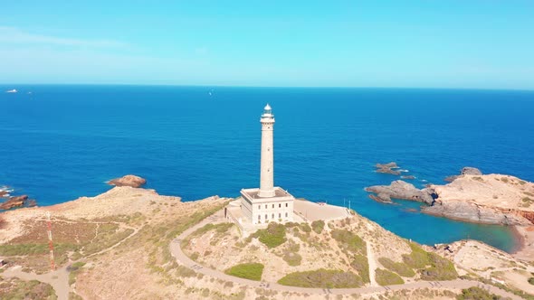 Aerial View of a Rock and a Lighthouse on the Sea