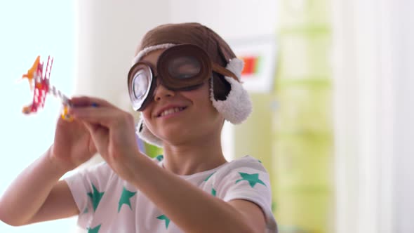 Boy in Pilot Hat Playing with Airplane Toy at Home 19