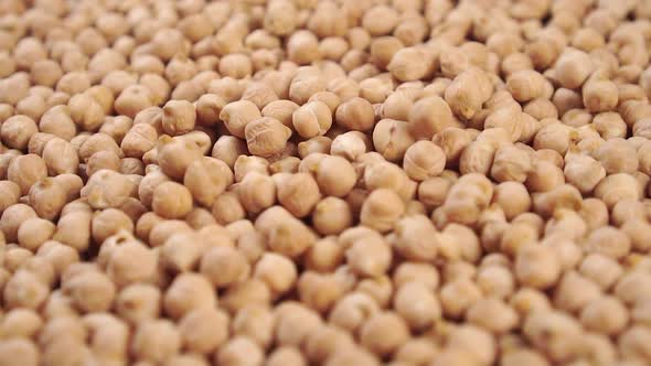 Slow motion chickpea legumes falling into a heap 