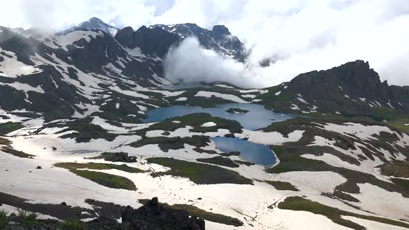 Approaching Clouds Passing Through the Valley to the High Altitude Alpine Lake