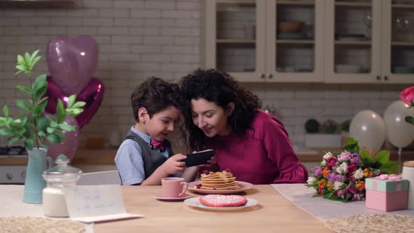 Mom with Son Watching Funny Video on Smart Phone