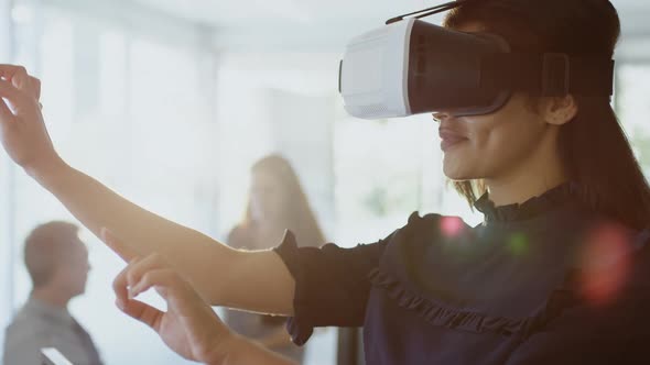 Businesswoman using virtual reality headset 4k