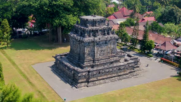 Majestic historical stone building of Mendut temple, aerial orbit view