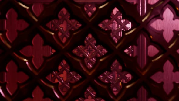 Seamless looping animation of a wooden screen in a confessional booth in church.