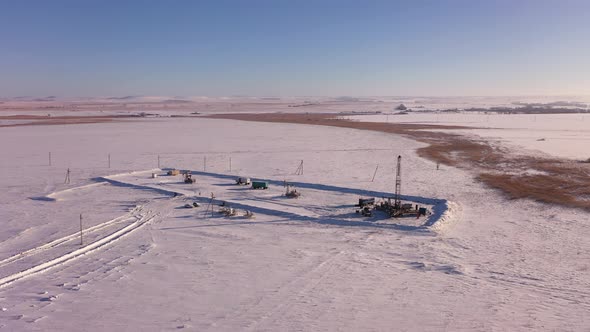 Pump Jack in Vast Oil Fields in Winter