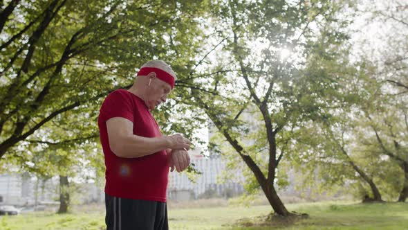 Senior Sport Runner Man Using Smart Watch Tapping Touchscreen, Tracking Result After Fitness Workout