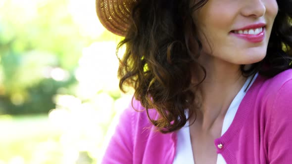 Close-up of beautiful woman sitting in park