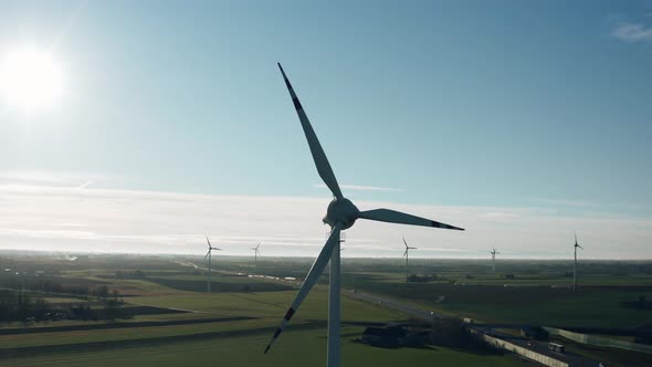 Aerial Drone View Windmills Wind Turbines Producing Clean Ecological Electricity By Road in Green