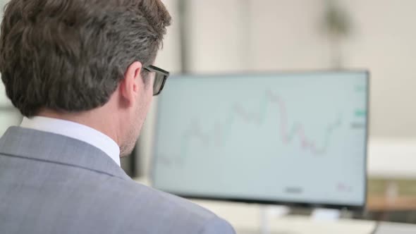 Businessman Using Desktop Working on Project