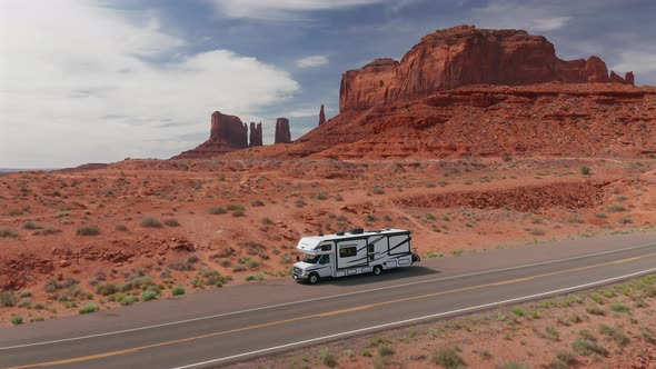 Aerial view of an RV pulled over to the side of the road in Monument Valley, Utah