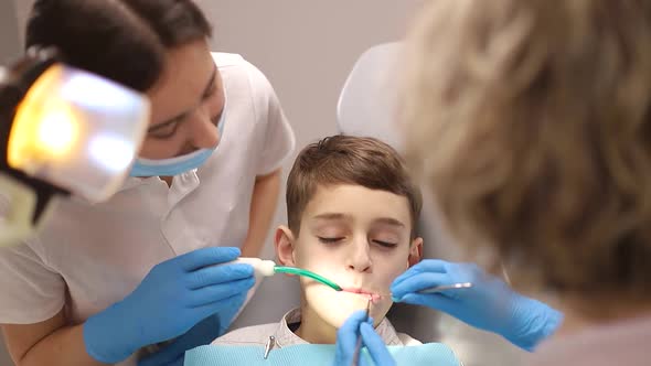 Little boy treats teeth, dentists examine a child's teeth, the concept of dentistry