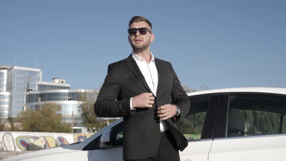 Business Man in a Suit Near the Car