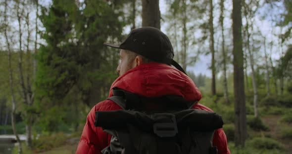 Travel Blogger Man with Backpack Hike in Forest