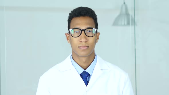 Portrait of Afro-American Doctor in Glasses Looking At Camera