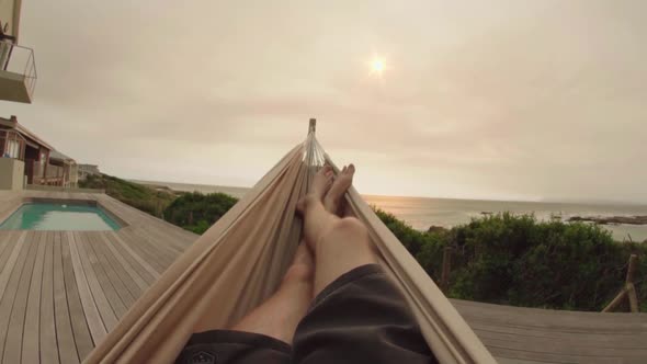 Young man relaxing on the hammock. point of view shot in slow motion.