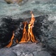 Bright Flame Burns Among Grey Rocks on Yanartas Mountain - VideoHive Item for Sale