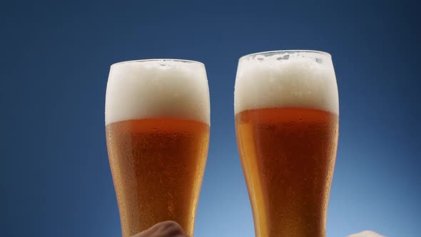 Two Glasses Full of Frothy Beer