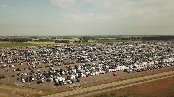 Many new and occasion Cars on a huge parking lot waiting for shipment, Aerial