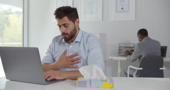 Unhealthy Male Employee Coughing Having Ache in Chest Working in Office