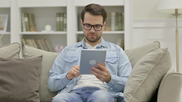 Young Man Using Tablet at Home